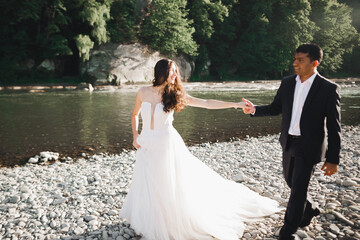 Wedding couple holding hands, groom and bride together on wedding day