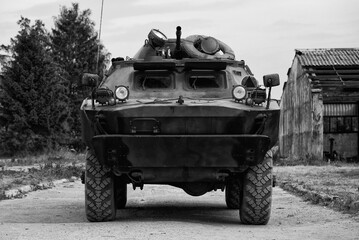 COMBAT RECONNAISSANCE/PATROL VEHICLE - A camouflage scout on a country road
