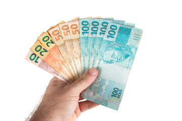 Hand holding Brazilian money banknotes. Brazilian finance concept - 527665759