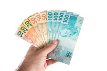 Fotobehang Hand holding Brazilian money banknotes. Brazilian finance concept © Gustavo
