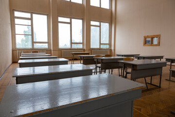 A fragment of the interior of the classroom with desks in an educational institution