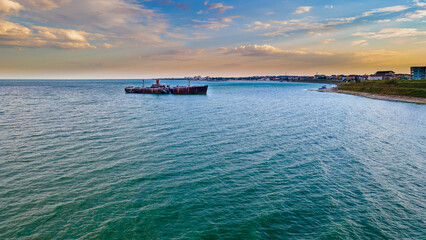 Drone photography of a rusty shipwreck at the Black Sea located next to Costinesti beach, in...