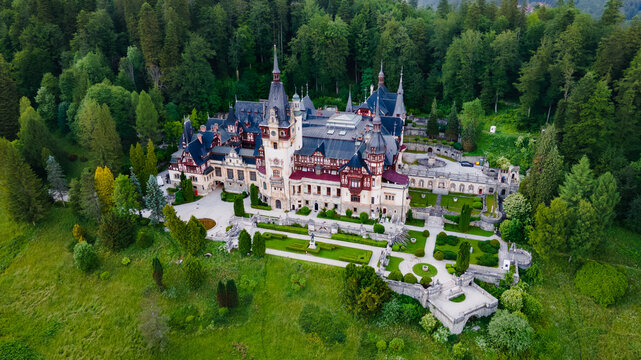 Aerial photography of Peles Castle in Romania. Photography was shot from a drone at a higher altitude with camera pointed downwards towards the castle.