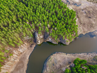Aerial view of river shore with rocks and forest. Spring or autumn season. Iset River, Ural mountains, Russia.