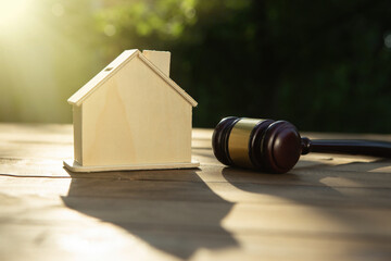 Real estate and protecting insurance concept - Invest to a family home. House model and judge gavel
