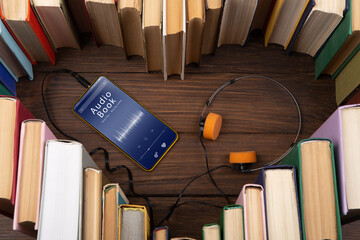 Listening Audio book concept - heart shape of book, headphones and smartphone with audiobook...