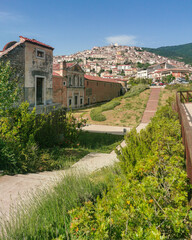 The entrance of the Certosa di San Lorenzo with Padula town in the background, Campania, Italy