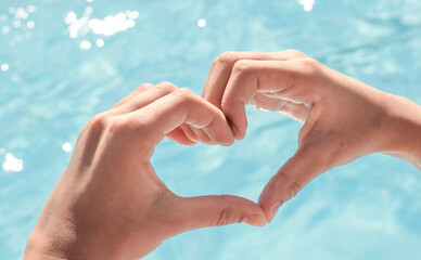  pool day teenager have fun.girl hold bitten ice cream cone,candy lollipop on stick or heart shape from hands.clean water pool background.vacation sea time concept.tasty delicious sweets.love girl