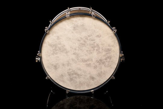 drum head of bass drum on a black background with reflection, for advertising and inscription