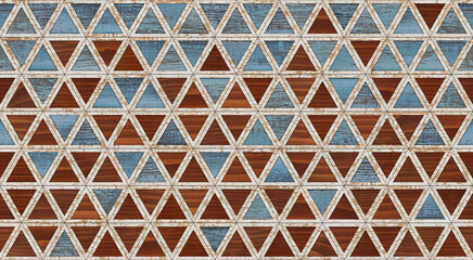 Seamless wooden background with triangular pattern. Old colorful decorative wall panel made of natural wood.