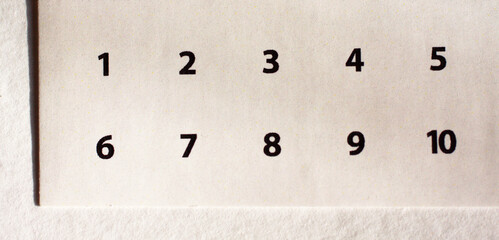 A piece of paper with printed numbers from 1 to 10 in order. Top view. Mathematics, math, finance, education, business, counting concept background