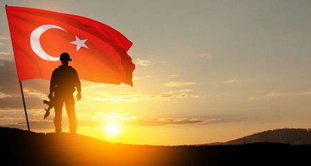 Silhouette of soldier with Turkey flag on background of sunset. Concept of crisis of war and...