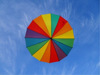 Obraz premium Colored umbrella in the sky. Bottom view.