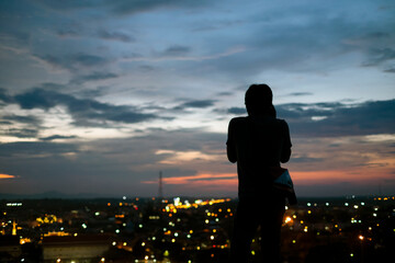 Fototapeta premium Behind the shadow of a photographer photographing the city from a height