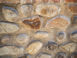 imagen textura pared de piedras redondas con las juntas de cemento 