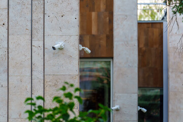 Several surveillance cameras on the corners of the building