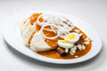 beef goulash with onion rings, boiled egg and dumplings