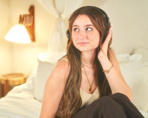 Woman listening to podcast at home