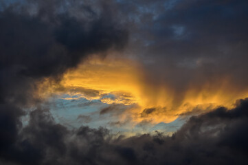 Sunset in dark clouds