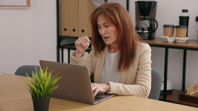 Middle age woman business worker suffering for neck pain at office
