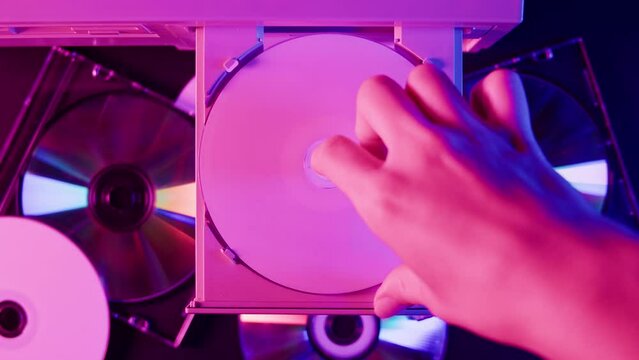 Using CD circle disk close-up. Old dvd player, disc drive top view. Music recorder, playing retro computer games. 