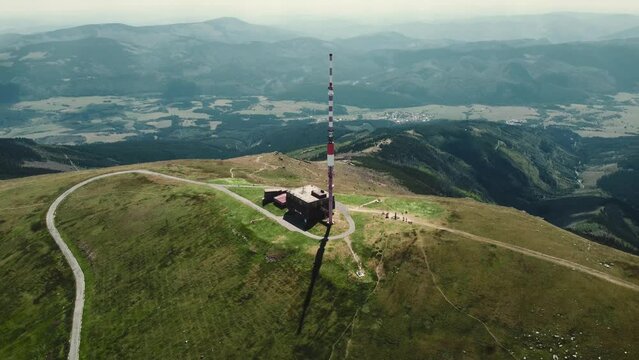 Aerial 4k footage of broadcasting tower on the top of Kralova Hola mountain in Slovakia - Low Tatras. Beautiful and stunning scenic view of mountain with high mountains around.