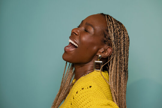 Portrait beautiful, happy woman with long braids laughing