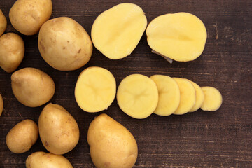 Fresh potatoes on a wooden background