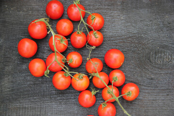 Fototapeta na wymiar Fresh tomatoes on a wooden background