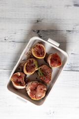 pork tenderloin in bacon on pepper