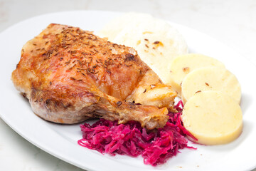 roasted goose leg with red cabbage and dumplings