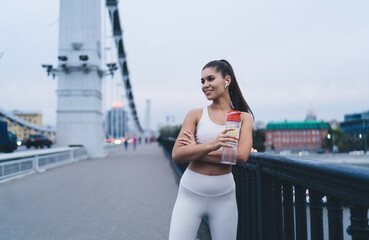 Sportswoman listening to music in city