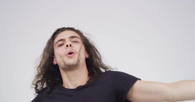 Happy rock punk, man dancing to music, musician hair head bang and freedom time. Young male dancer has fun moving body, crazy dance party alone and enjoy audio streaming service