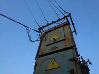 Old electric power pole. Electrical transformer. Electricity city communications, power supply.