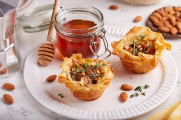 Rose shaped filo pastry cakes with apples, pears, honey  and almond nuts. Delicious autumn homemade dessert.