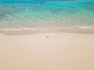Fototapeta na wymiar Shadow of drone on an empty beach in the Bahamas