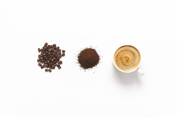 Coffee beans, grounded coffee, and a cup of coffee on white background. Horizontal format with copy space. 