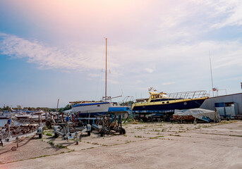 Fototapeta premium Boats and yachts on the shore. Maintenance of ships in the yacht club