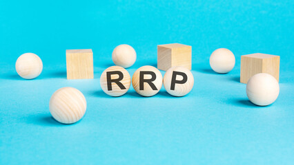 acronym rrp on wooden balls, bright blue background