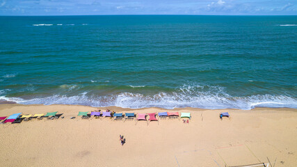 Aerial view of Caraiva beach, Porto Seguro, Bahia, Brazil. Colorful beach tents, sea and river