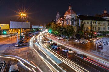 A night shot of cars on a street moving on Strand Rd in center of Yangon, Myanmar, Burma