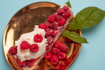 Delicious piece of cake with fresh raspberries a Blurred white background. Sweet concept. Excellent image for dessert banners and advertisements.