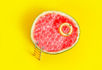 Pool concept - watermelon fruit with buoy and poolside ladder