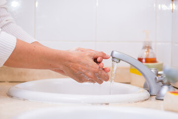 women's hands washing with soap, towel drying, prevent disease, cholera, cholera
