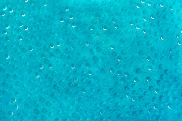 Close-up water drops pattern on glass surface abstract background. Toned aqua image in trendy color. Copy space.