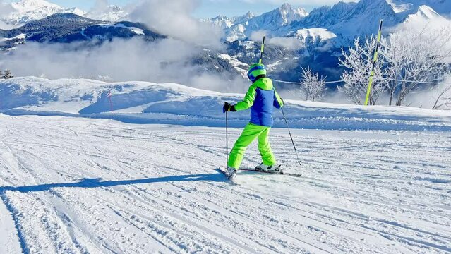 Boy ski fast downhill over beautiful Mont Blanc mountain summit