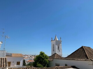 Fototapeta na wymiar White storks on a local church in Faro, Portugal