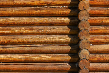 A log wall construction with a swedish cope log profile. A heavily cracked wooden wall as a background - obrazy, fototapety, plakaty