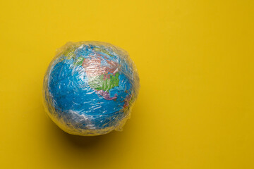 planet earth in the plastic wrap, concept of global environmental problems