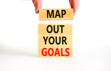 Support and map out your goals symbol. Concept words Map out your goals on wooden blocks on beautiful white table white background. Businessman hand. Business, support and map out your goals concept